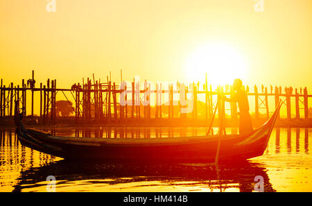 Fishman under U bein bridge at sunset, Myanmar landmark in mandalay Stock Photo