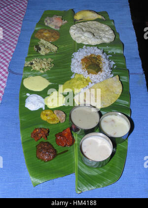 Onam Sadhya is a multi-course meal with 11 to 12 vegetarian dishes and is served on the last day of Onam. South Indian Thali or meal. Kerala, India Stock Photo