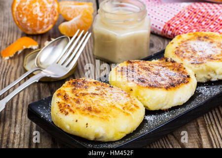 Hot sweet cheesecakes with tangerines and honey Stock Photo