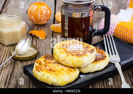 Hot sweet cheesecakes with tangerines and honey Stock Photo