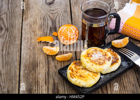 Hot sweet cheesecakes with tangerines and honey Stock Photo