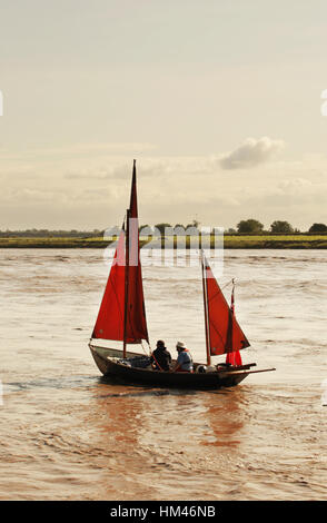 Small sailing boats riding the Severn Bore wave, River Severn, Newnham, Gloucestershire. Stock Photo