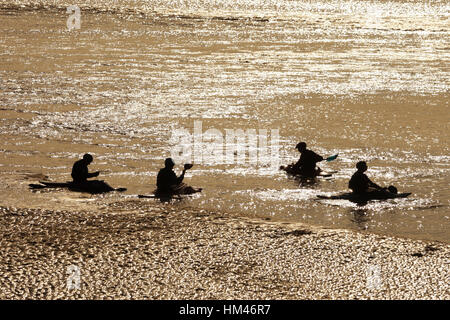 Surfers and water sports enthusiasts on the River Severn Bore, Newnham, Gloucestershire. Stock Photo