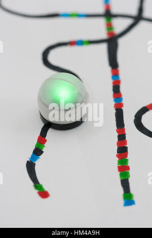 Single green Ozobot on hand drawn code line. Stock Photo