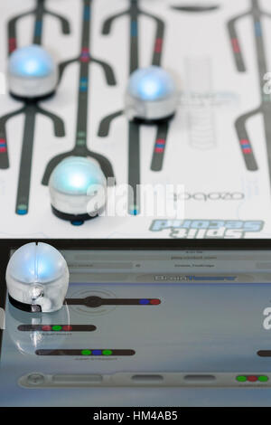 https://l450v.alamy.com/450v/hm4ab5/ozobots-racing-on-paper-and-another-plays-a-web-based-game-on-a-tablet-hm4ab5.jpg