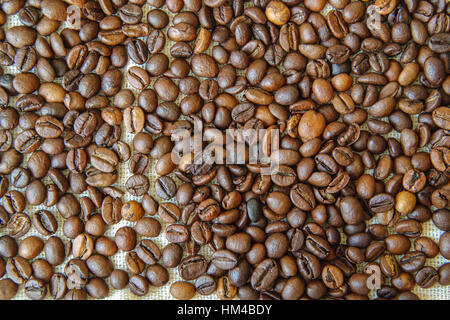 many brown coffee beans on a white bag Stock Photo