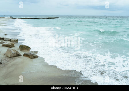 The coastline with concrete slabs on the shore Stock Photo