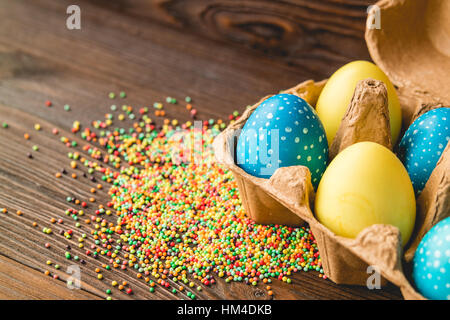 Easter decoration of colored eggs on a wooden table Stock Photo
