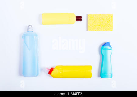 Blue and yellow bottles of detergent and sponges on a white background, top view Stock Photo