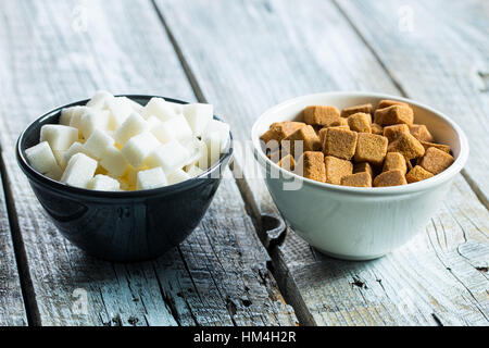 Brown and white sugar cubes in bowl. Stock Photo
