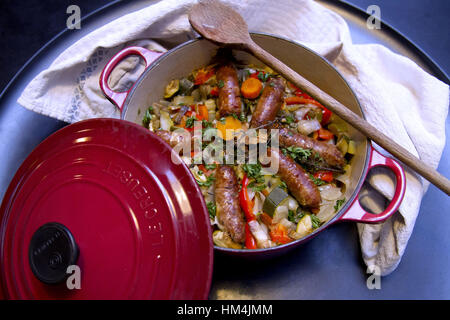 Le Creuset casserole dish in the famous orange colour. It's a premium French  cookware manufacturer known for its colorfully-enameled pots and pans Stock  Photo - Alamy