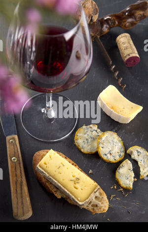 Cheese platter and glass of red wine. Stock Photo