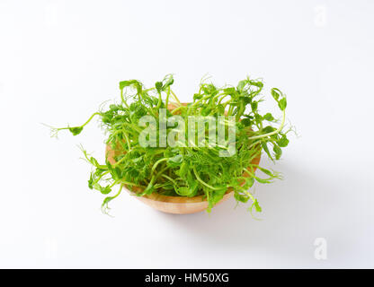 bowl of green pea sprouts on white background Stock Photo