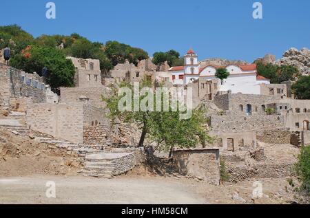 The church of Agia Zoni stands among the ruins of the abandoned village of Mikro Chorio on the Greek island of Tilos. Stock Photo