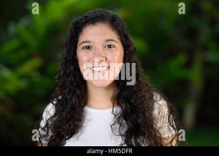 teen girl with curly hair smiling Stock Photo