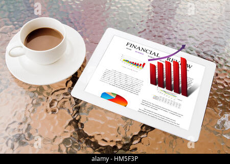 Tablet PC and coffee on table  shows financial review Stock Photo