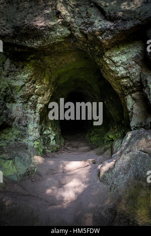 Hermit's cave in the quarry at Alderley edge in Cheshire, England. A small cave behind the Wizard pub. Stock Photo