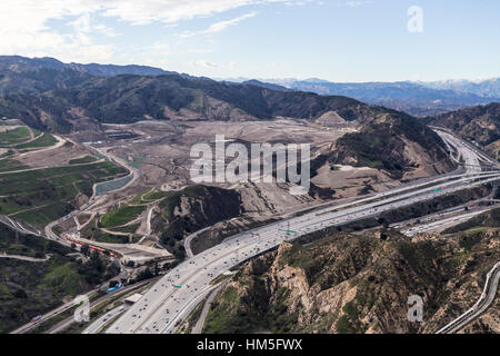 Aerial view of Golden State 5 Freeway and massive garbage landfill in the Newhall Pass in Los Angeles California. Stock Photo