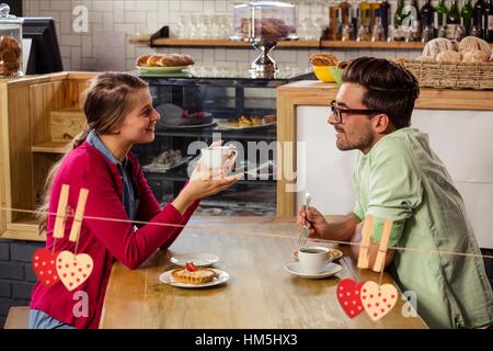Couple interacting with each other while having coffee Stock Photo