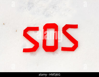 the universal distress signal sos on a snowfield Stock Photo