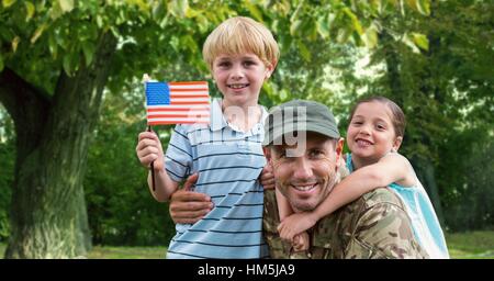 Portrait of father in soldier uniform with their kids at park Stock Photo