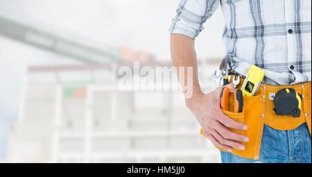 Handyman with hands on hip and tool belt Stock Photo