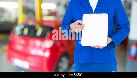 Mechanic showing a clipboard in garage Stock Photo