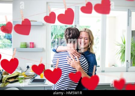 Happy couple embracing each other in kitchen Stock Photo