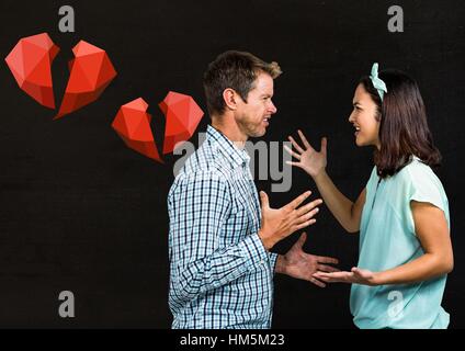 Couple arguing with each other against black background Stock Photo