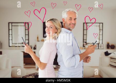 Portrait of mature couple using mobile phone Stock Photo