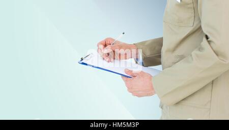 Mid section of delivery man writing on clip board Stock Photo