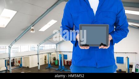 Mid section of mechanic holding digital tablet Stock Photo