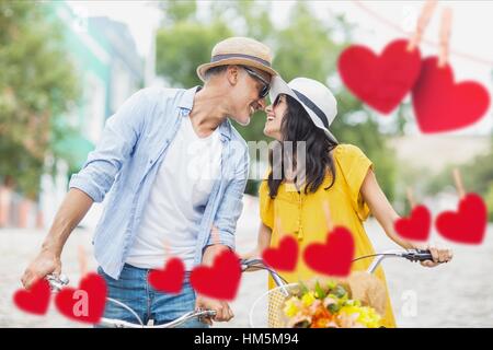 Romantic couple on bicycle looking face to face