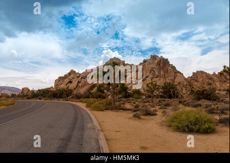 Paved Road and spectacular rock formations at Joshua Tree National Park, California, USA Stock Photo