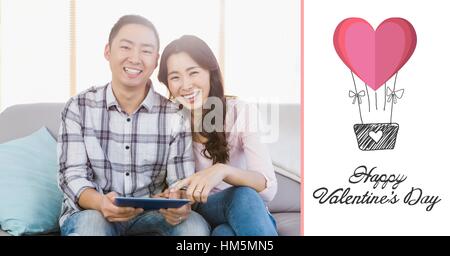 Portrait of couple using digital tablet at home Stock Photo