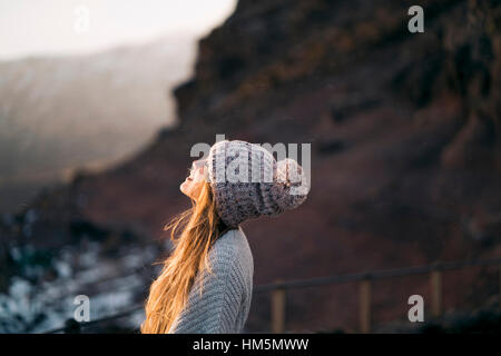 Side view of smiling woman in warm clothing Stock Photo