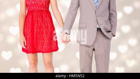 Mid-section of couple holding hands Stock Photo