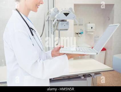 Mid section of doctor using laptop Stock Photo