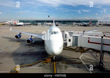 British Airways 747 jumbo jet airplane plane at Heathrow terminal 5 airport waiting for boarding Stock Photo