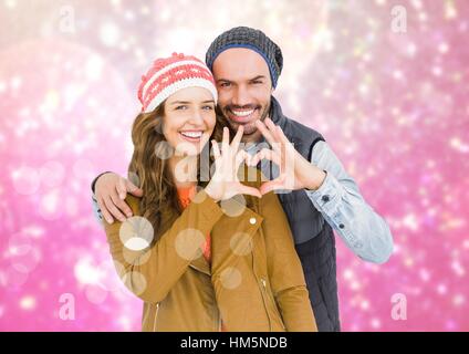 Couple forming heart shape with hands against digitally generated background Stock Photo