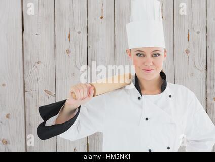 Portrait of smiling female chef holding rolling pin Stock Photo