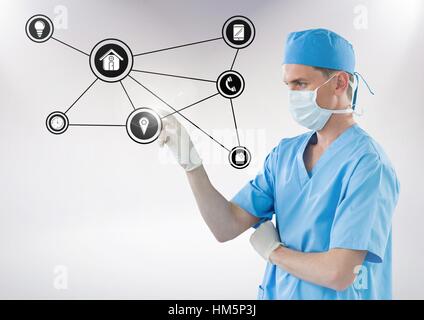 Doctor touching digitally generated connecting icons Stock Photo