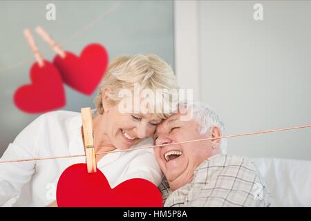 Senior couple embracing on sofa Stock Photo