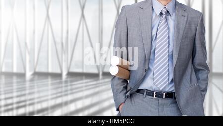 Mid-section of businesswoman with rolled charts Stock Photo