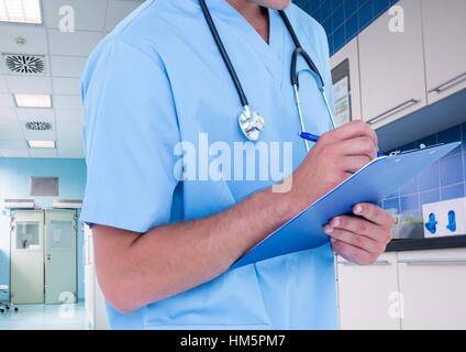 Mid section of doctor writing in notepad Stock Photo
