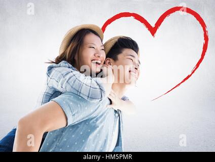 Happy man giving woman piggyback Stock Photo