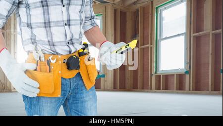 Mid section of handyman holding worktool Stock Photo
