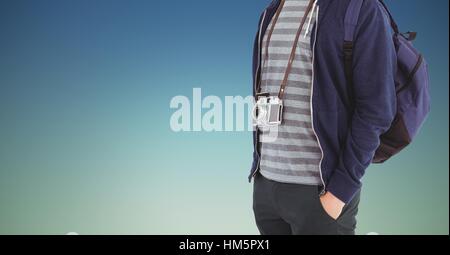 Mid section of tourist with camera and backpack Stock Photo