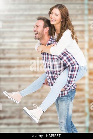 Happy man giving piggy back to woman Stock Photo