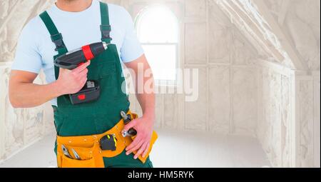 Handyman holding drilling machine at home Stock Photo